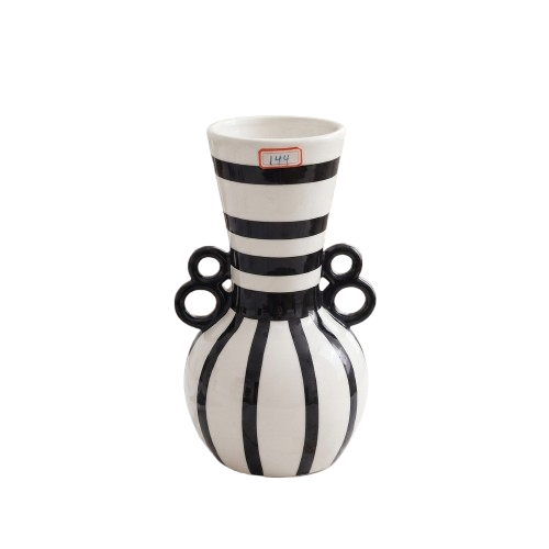 Black and white striped ceramic decorative vase with dual ring handles on a white marble surface.