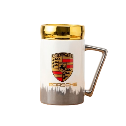 A high-end white ceramic mug by Gift by Hamza with the Porsche crest, elegant gold rim, and a modern metallic handle.