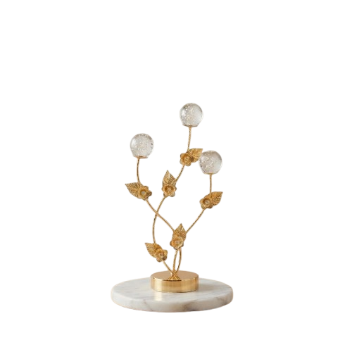 Golden decorative flower branch showpiece with crystal bubble spheres on a clean neutral background.