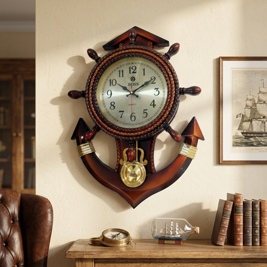 Vintage nautical ship wheel and anchor wooden wall clock hanging on a beige wall above a wooden console table.