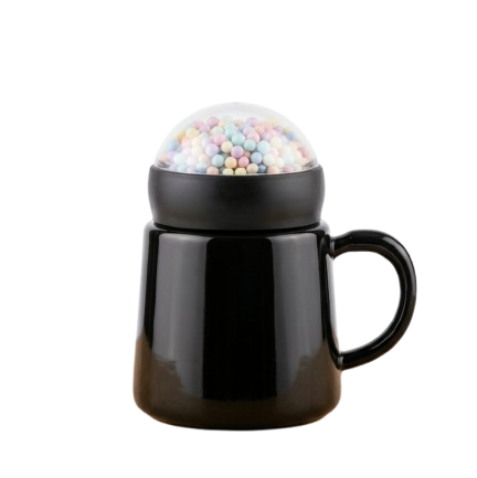 A modern glossy black ceramic mug by Gift by Hamza with a unique transparent dome lid filled with colorful pastel mini spheres.