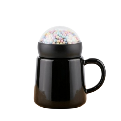 A modern glossy black ceramic mug by Gift by Hamza with a unique transparent dome lid filled with colorful pastel mini spheres.