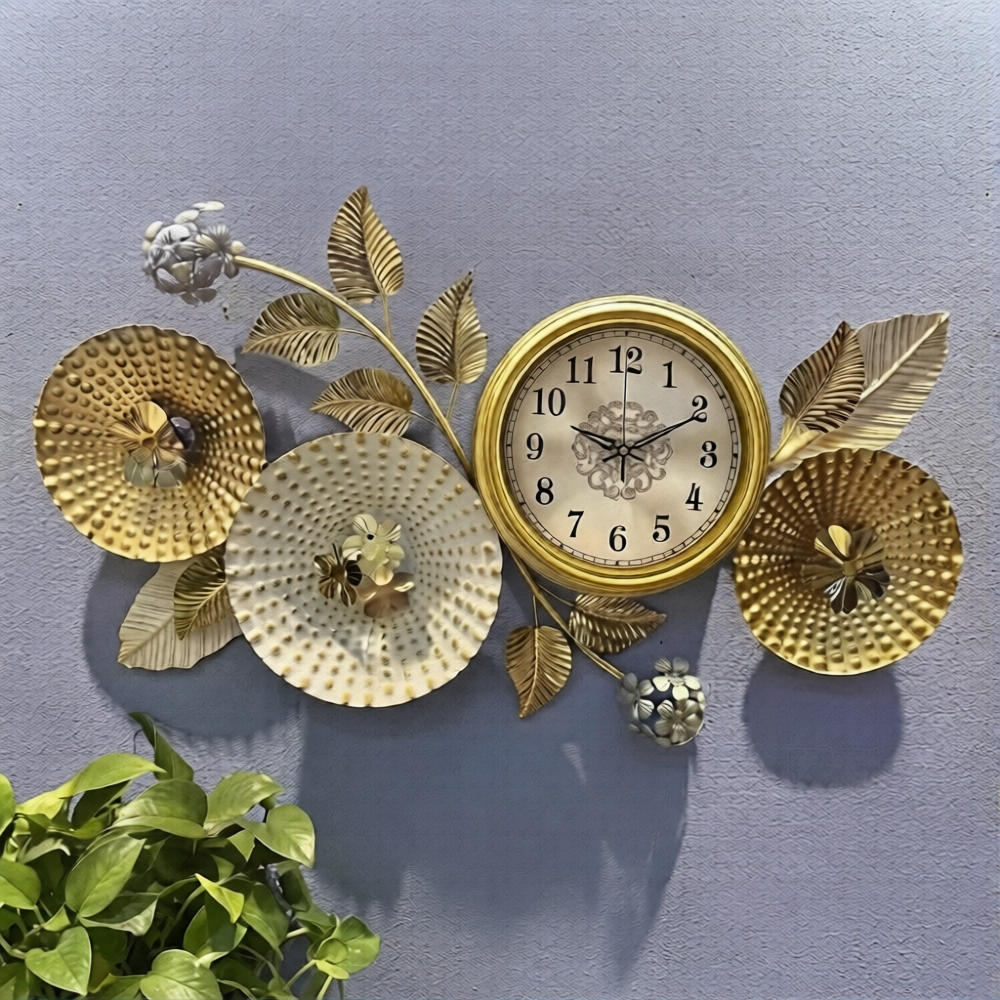 Golden floral branch metal art wall clock featuring textured flower disks and leaves mounted on a textured grey wall.