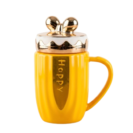 A bright yellow ceramic mug by Gift by Hamza featuring gold "Happy" text, metallic gold accents, and a cute golden bow-shaped lid.