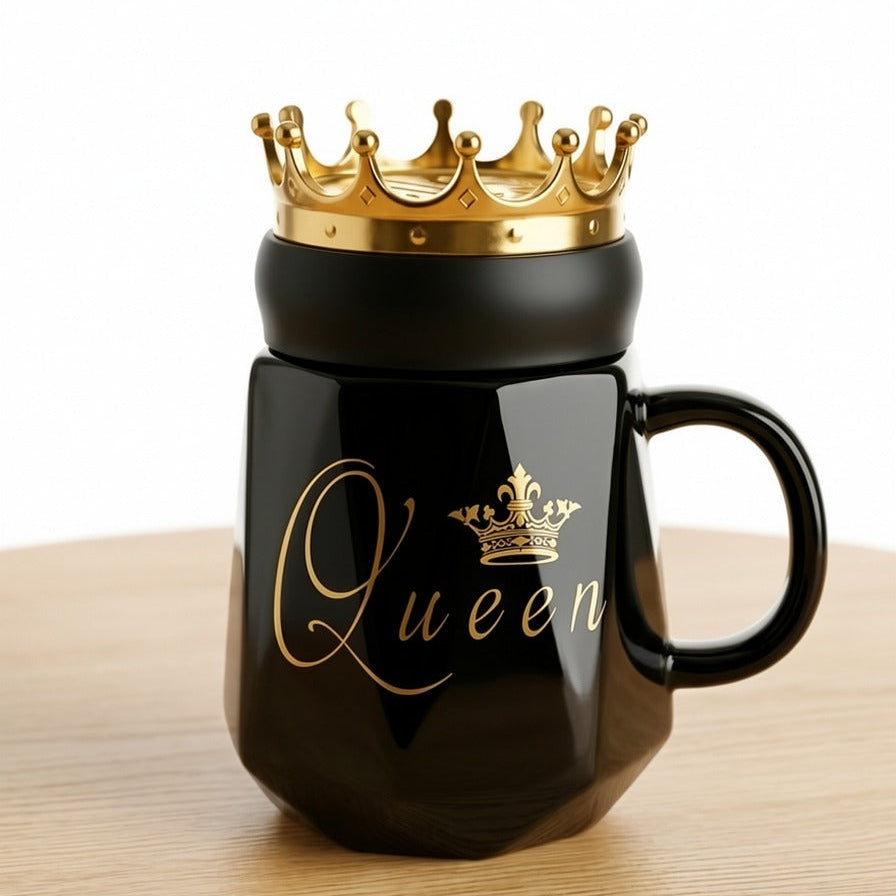 A premium black ceramic mug by Gift by Hamza featuring gold "Queen" calligraphy and a majestic golden crown-shaped lid.