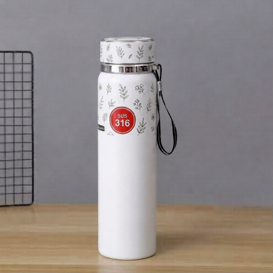A white SUS 316 stainless steel insulated water bottle with a botanical leaf print, a red label, and a black carrying strap on a wooden surface.